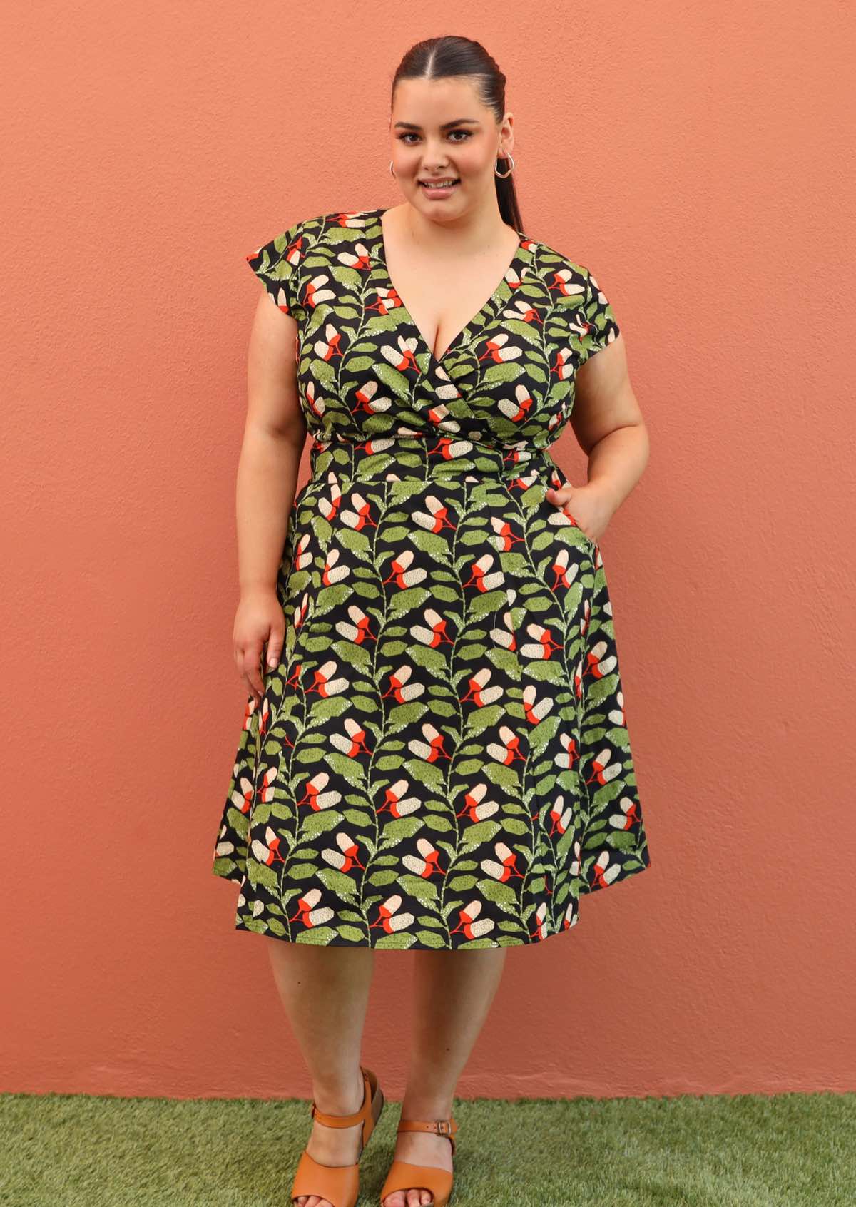 Plus size model wearing retro style cotton dress in black and green 