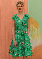 Model wears a retro style green dress. 