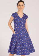 Model smiles in retro cotton dress with A-line skirt and pockets