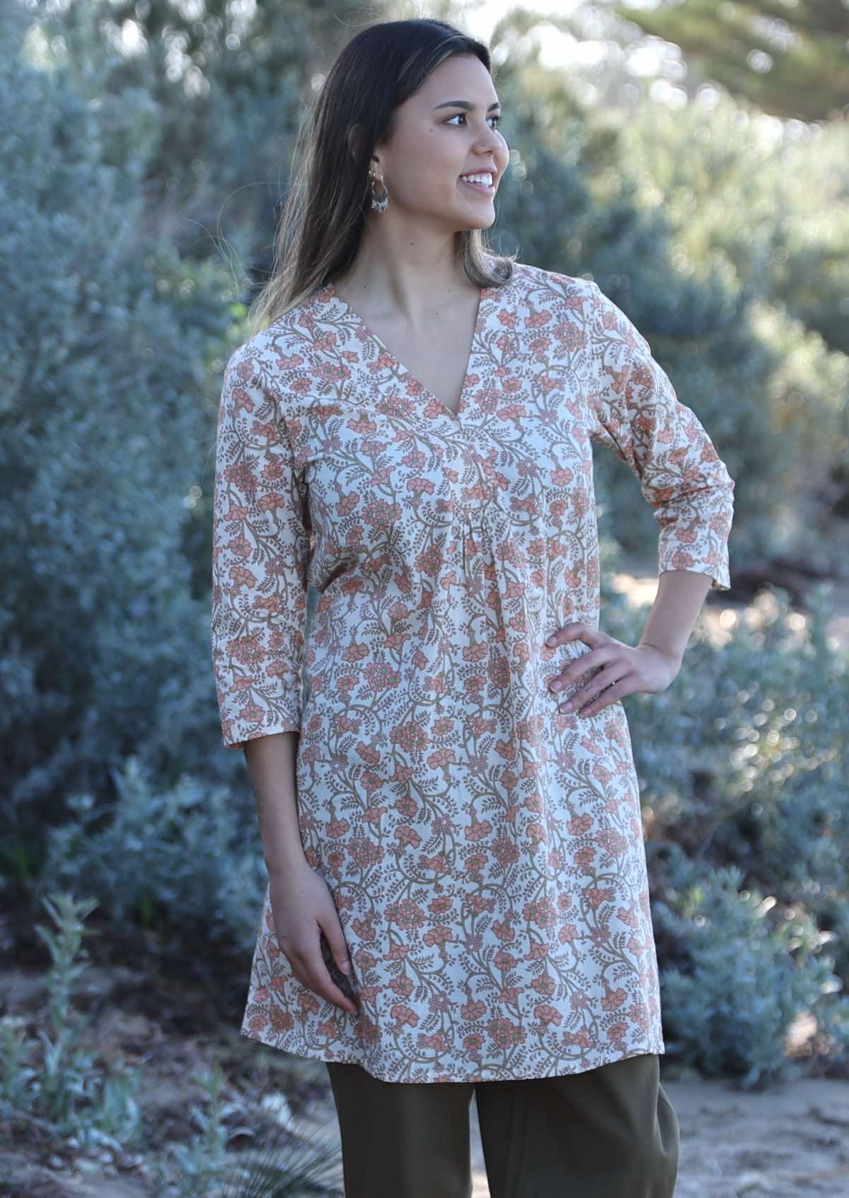 Model wears 100% cotton floral tunic with a cream base. This V neck tunic has 3/4 sleeves and a straight edge hem.