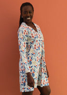 Model wears cotton tunic with V-neckline and long sleeves