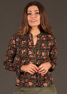 Model in Asha Top Wild Rose black floral print cotton blouse with mandarin style collar