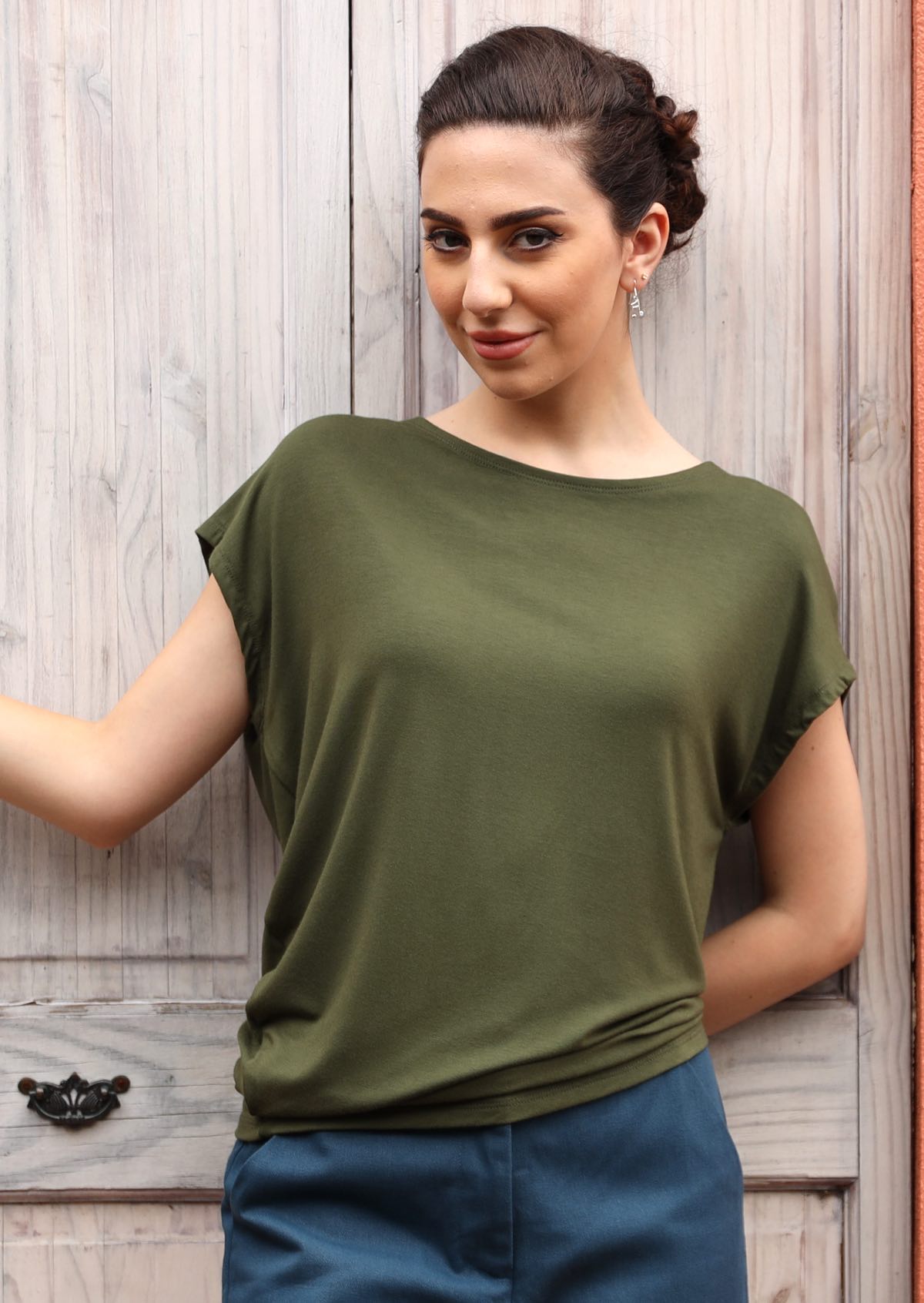 Woman wearing olive green rayon top
