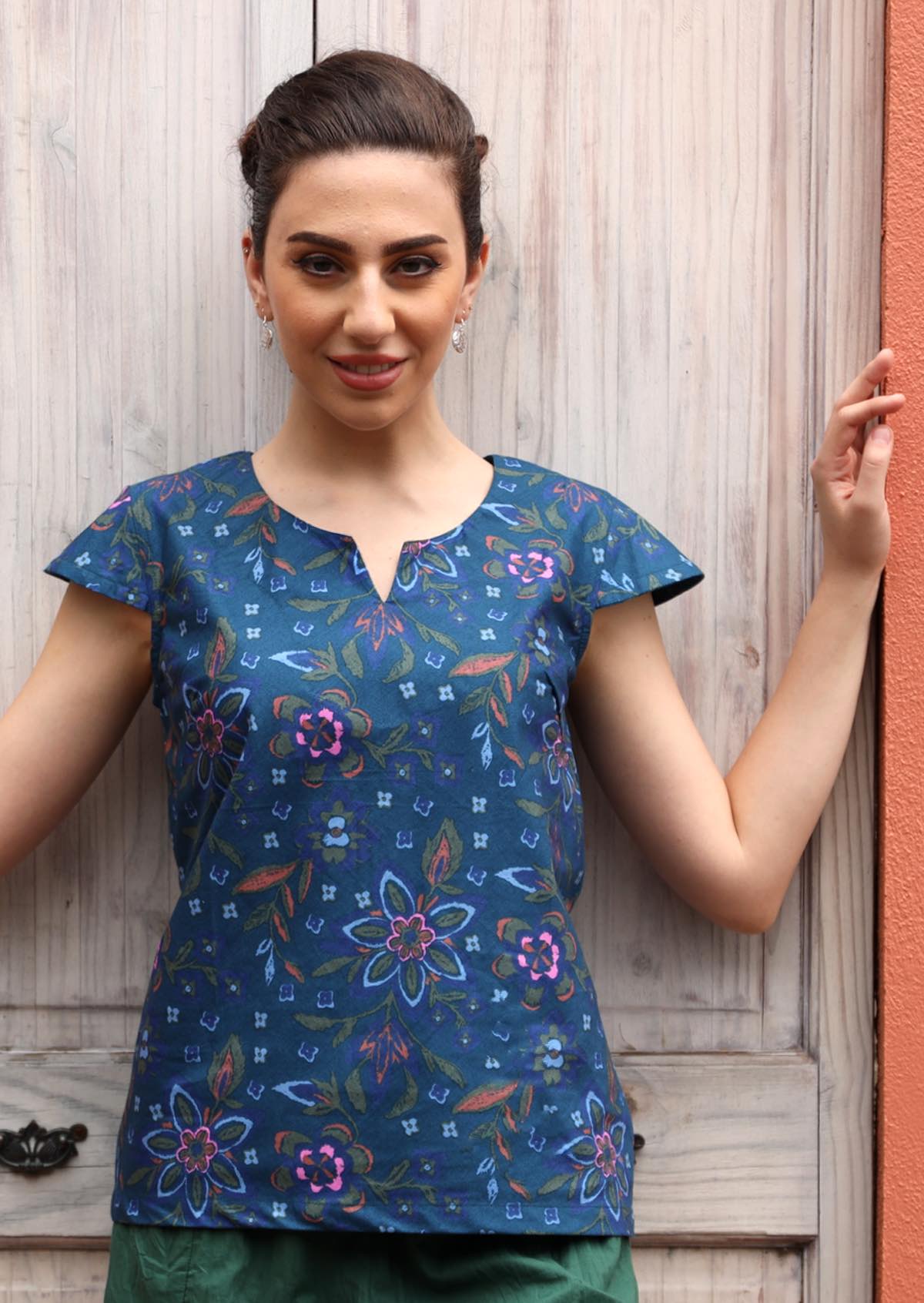 Model wears 100% cotton blue top with a sight stretch. 