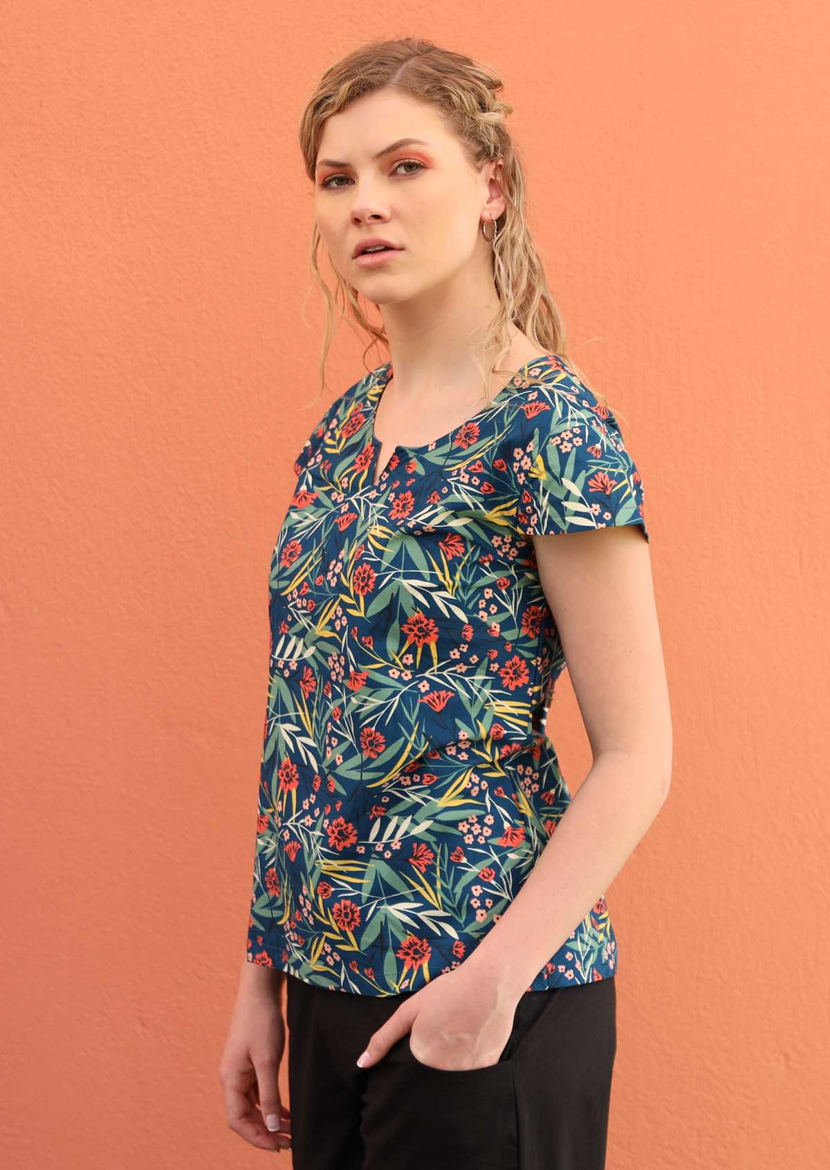 Model wears a 100% cotton top with cap sleeves. 