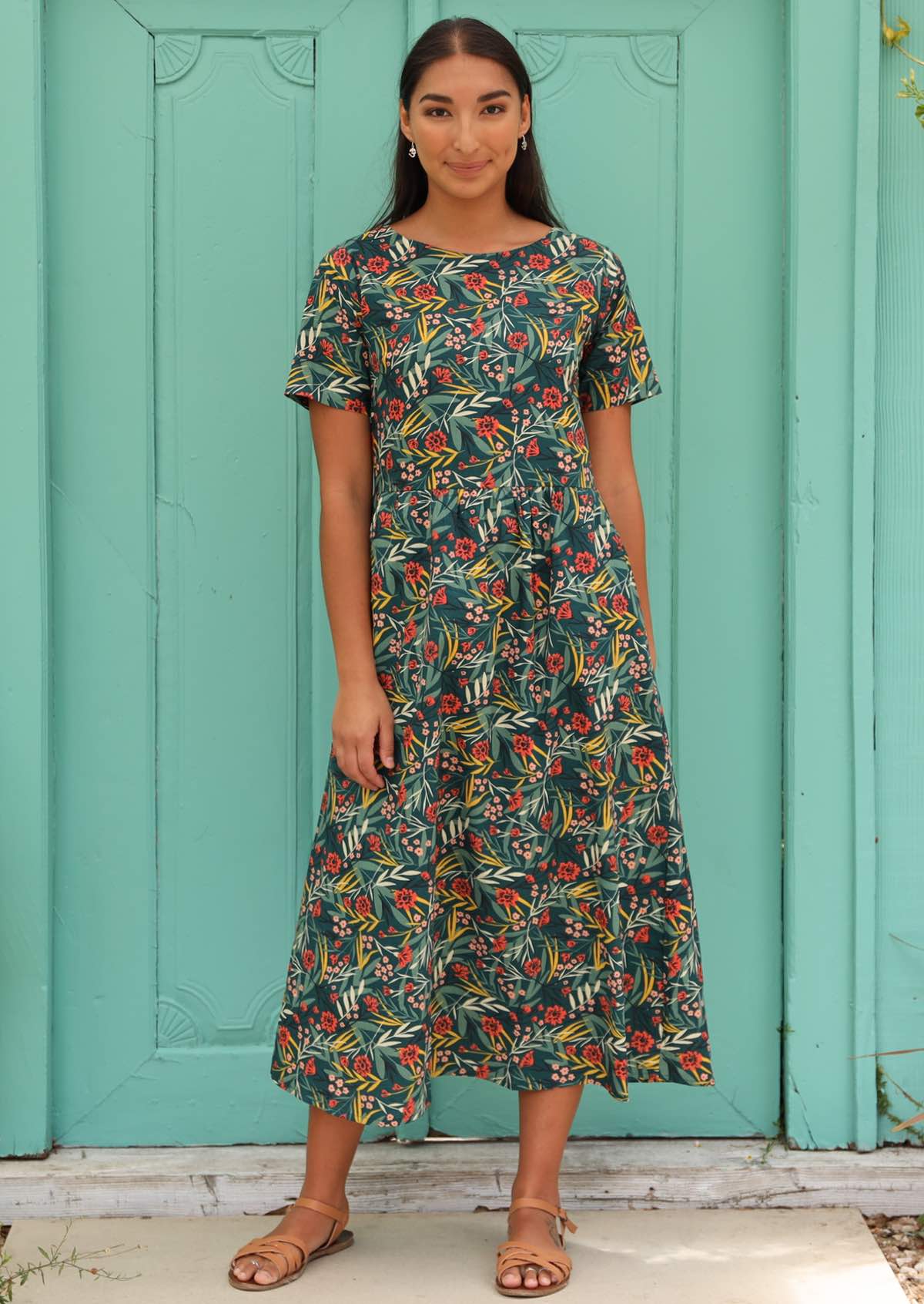 Model styles 100% cotton dress with earrings and sandals. 