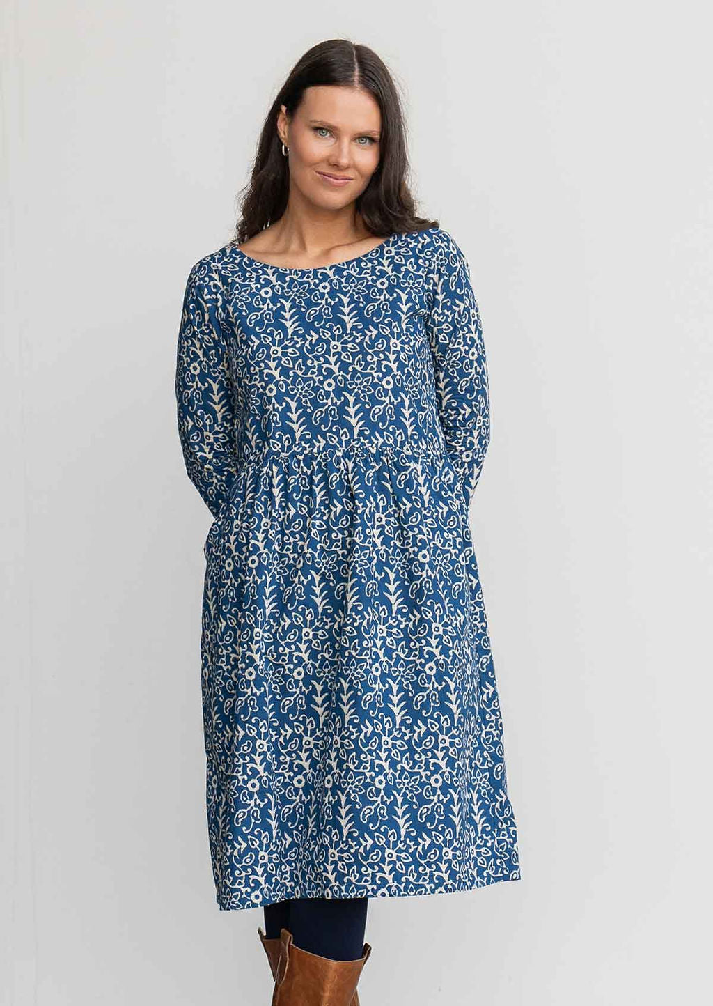 Woman in blue cotton, floral, knee length sundress 