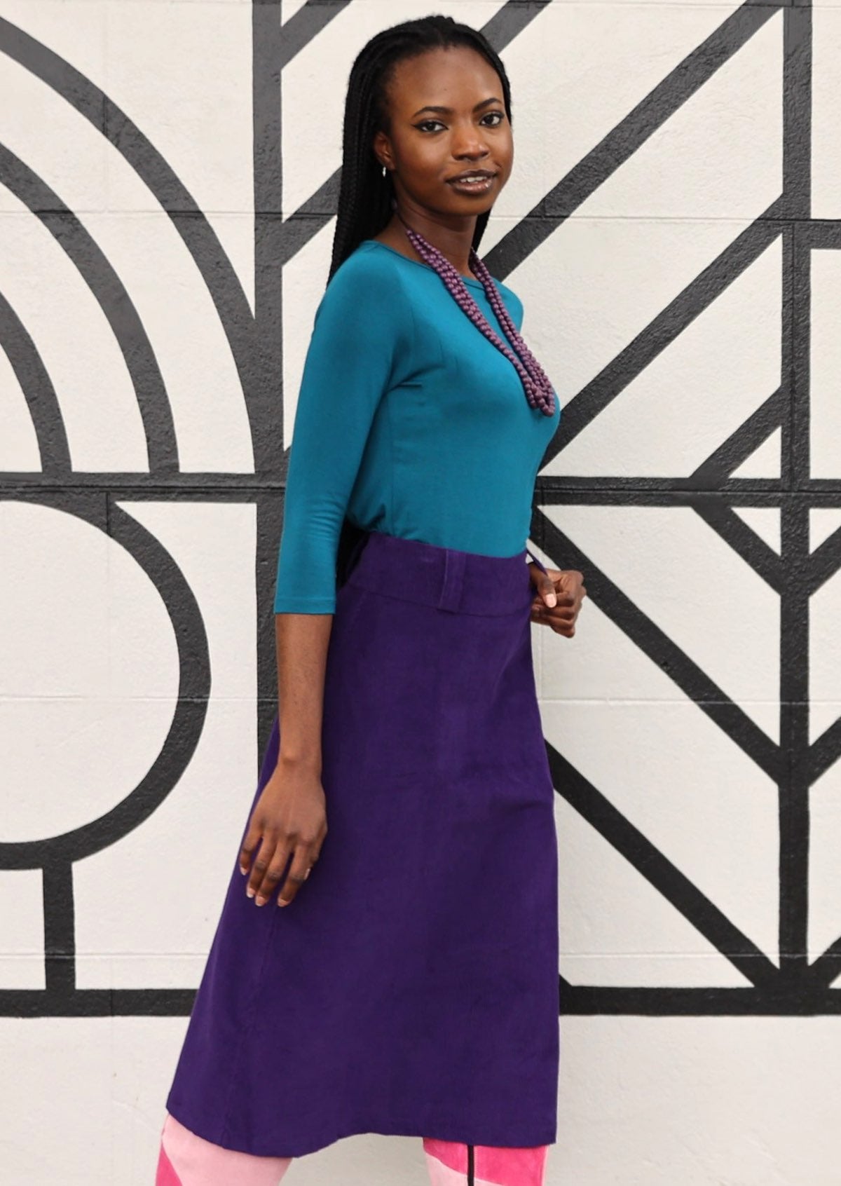 Purple A-line corduroy skirt with belt loops and back pockets