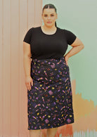 Curve sized woman wearing black space print cotton aline skirt with pockets
