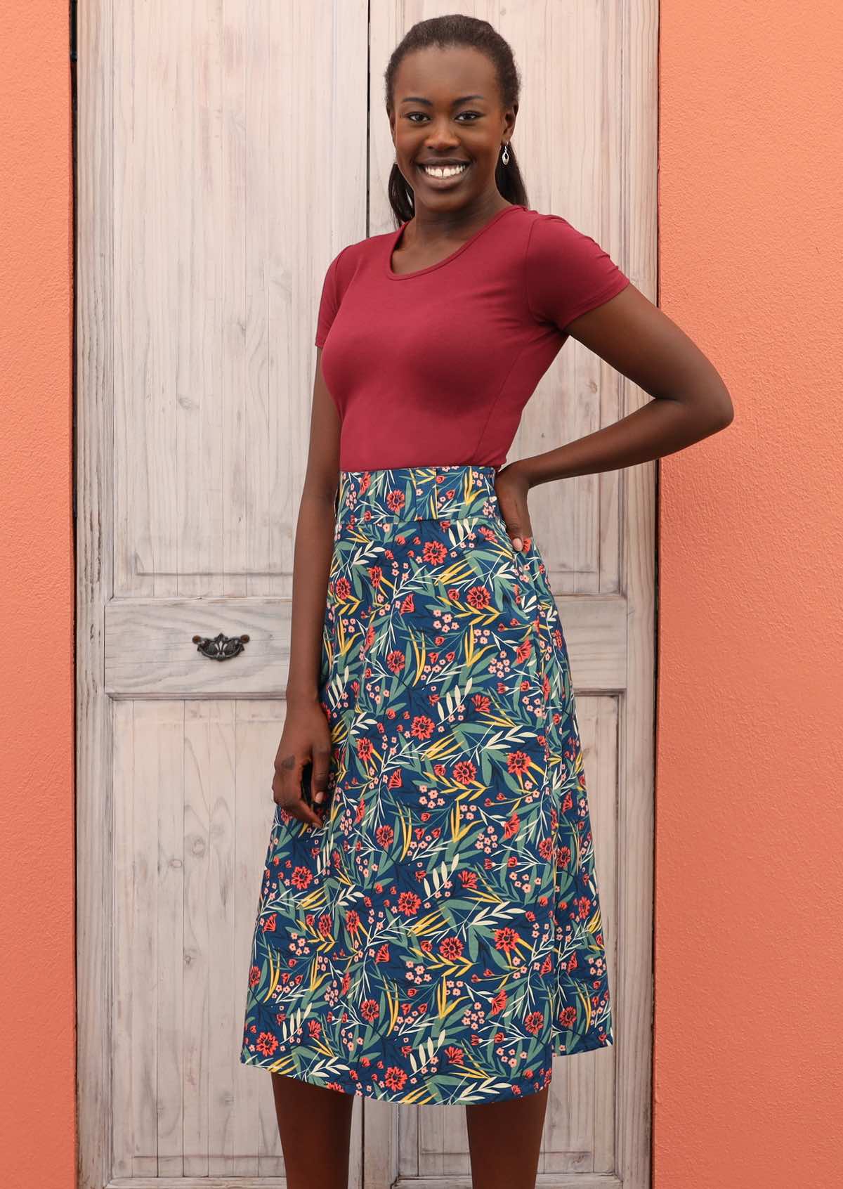 Smiling model wears 100% cotton floral skirt. 
