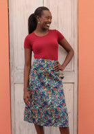 Model wears a 100% cotton shin length floral skirt with a blue base. 