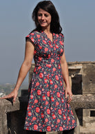 Model wearing deep navy blue based floral cotton retro style dress 