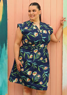 Model wears size 18 navy dress with floral print 