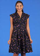Billie Dress Astro black base colourful space themed print retro style dress with v-neck box pleats a-line skirt side zip | Karma East Australia