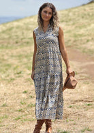 Model wears cream base cotton dress with blue stamped floral print