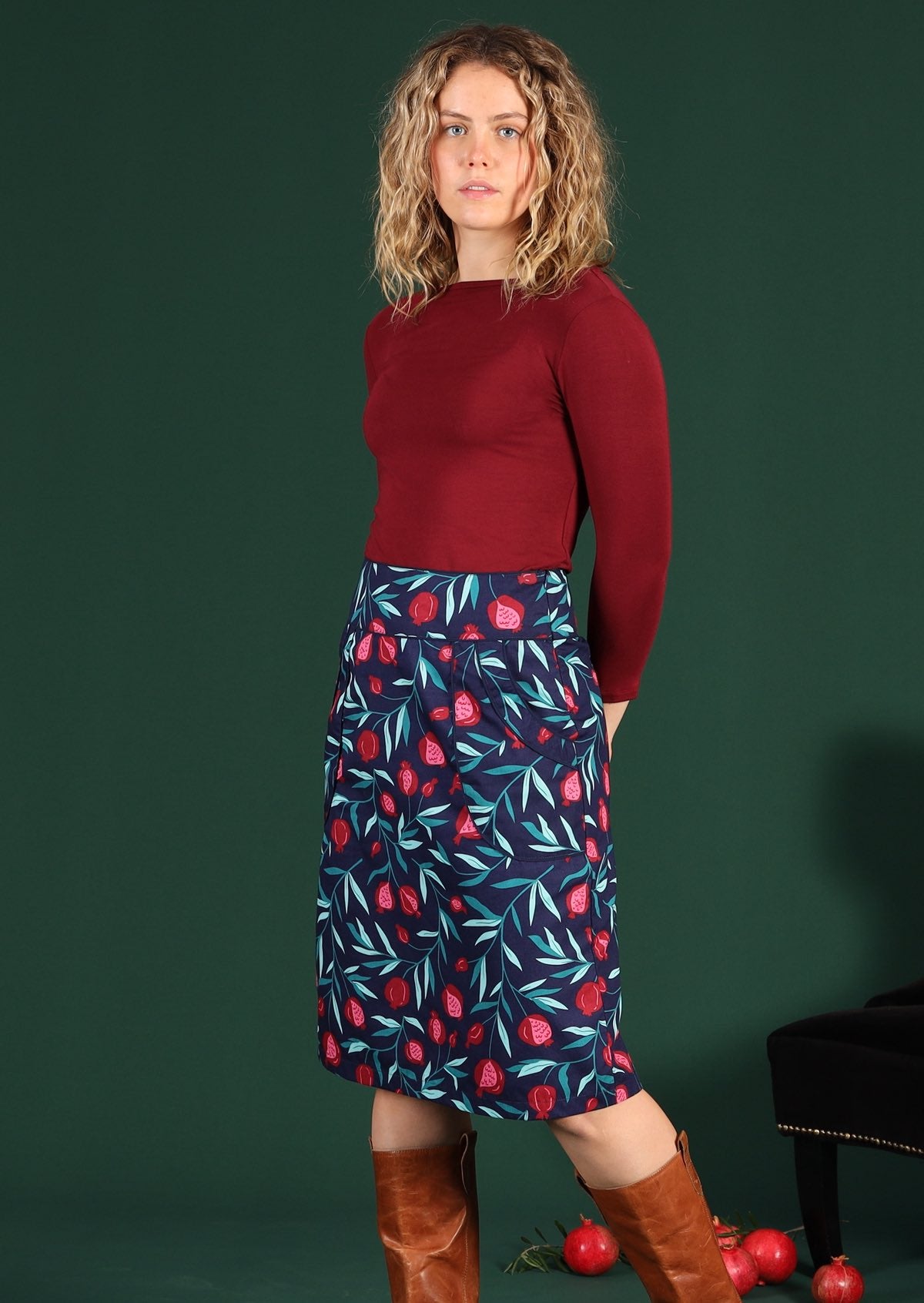 Model wears a pomegranate print retro skirt with pockets