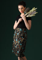Model wears botanical print with black base cotton skirt