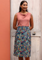Model wears knee length skirt with pockets. 