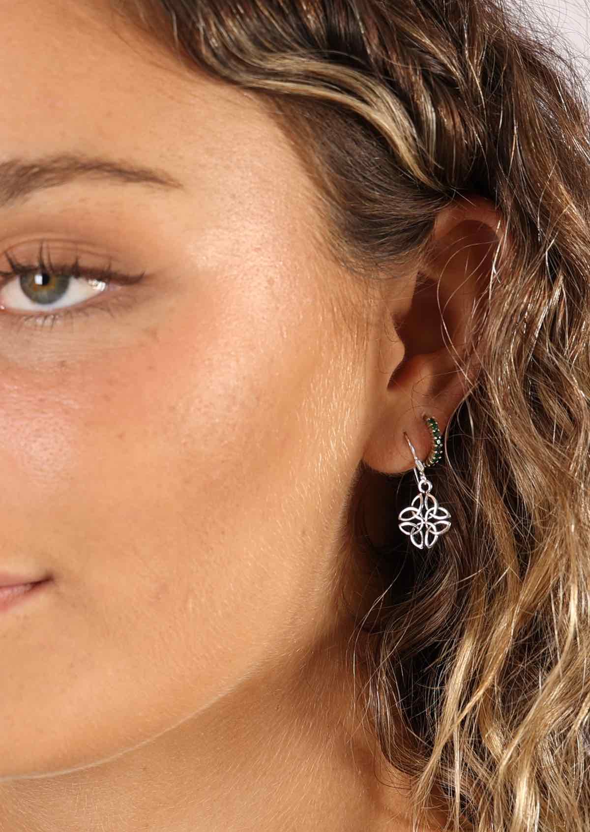 woman wearing silver Celtic dangle earrings
