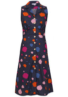 Sleeveless, button through dress with collar, gathers under the bust and pockets in navy based colorful spot print.