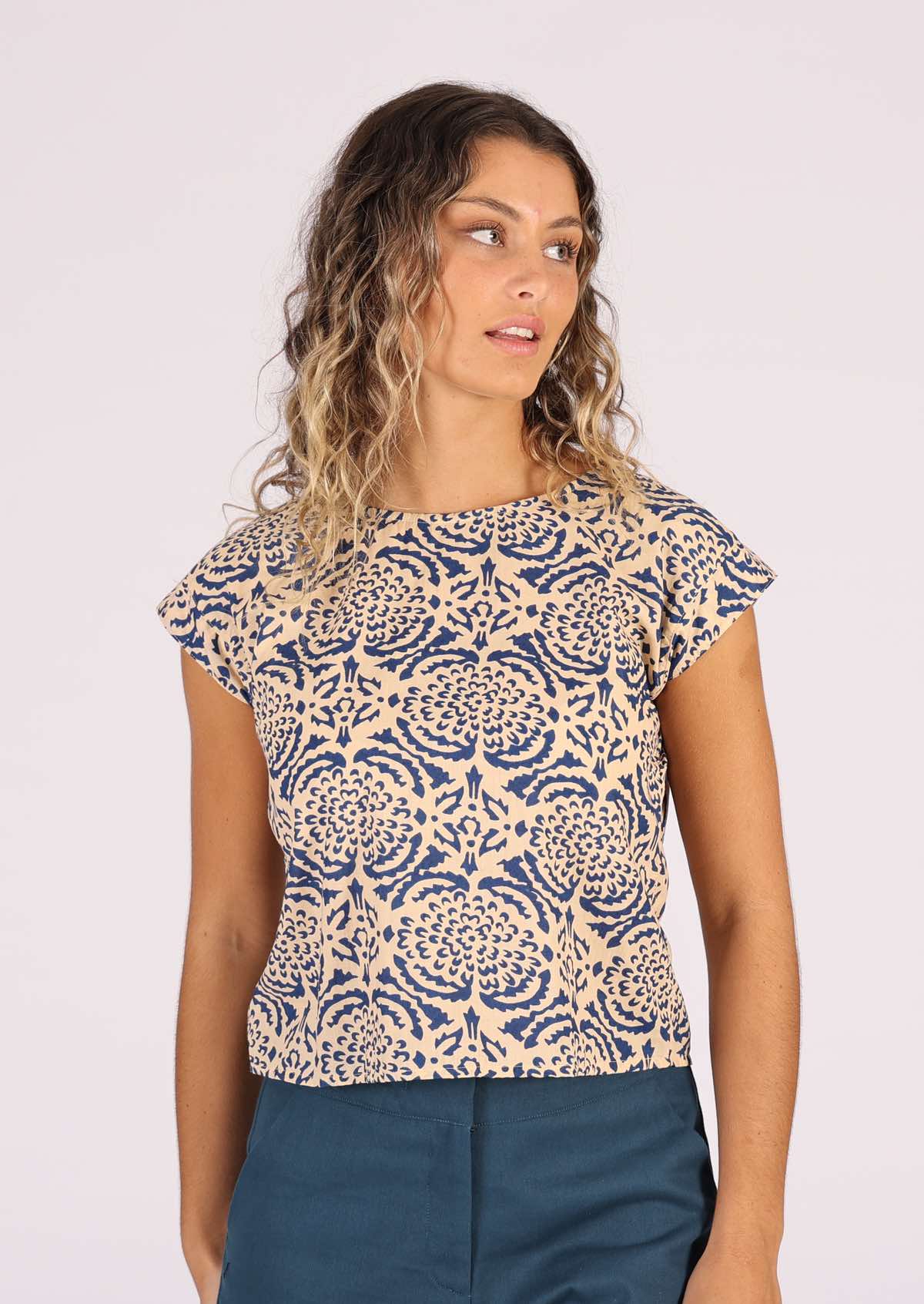 Model wears simple cotton top with flower print