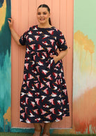 plus size model wears below knee navy blue cotton maxi dress with fun print 