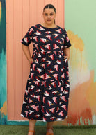 plus size model wears below knee navy blue cotton maxi dress with fun pelican print 