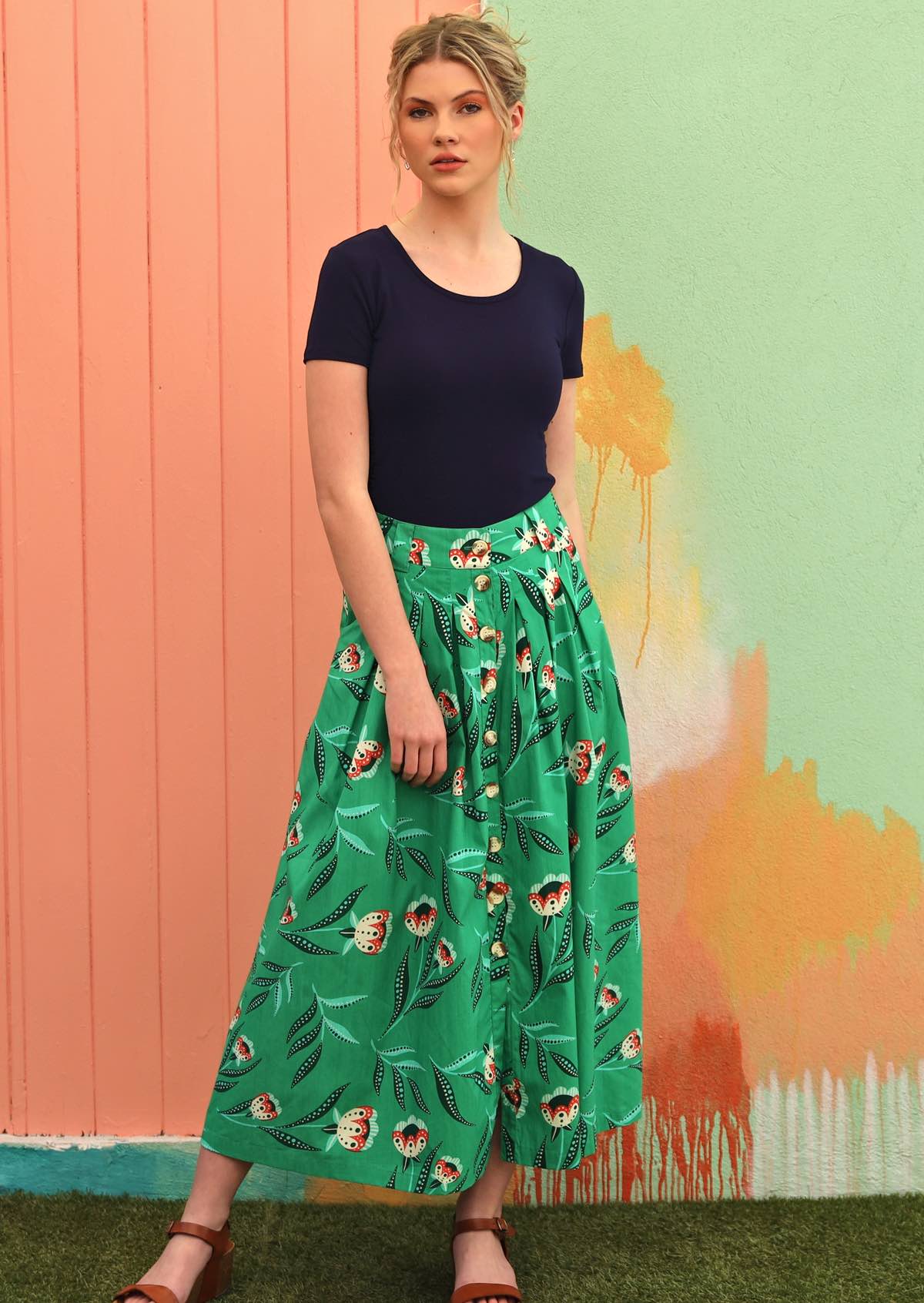Model wears button through midi length cotton skirt