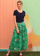 Model wears button through midi length cotton skirt