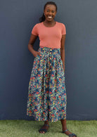 Model wears blue floral cotton button through skirt with pockets