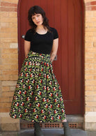 Model wears cotton midi skirt with box pleats