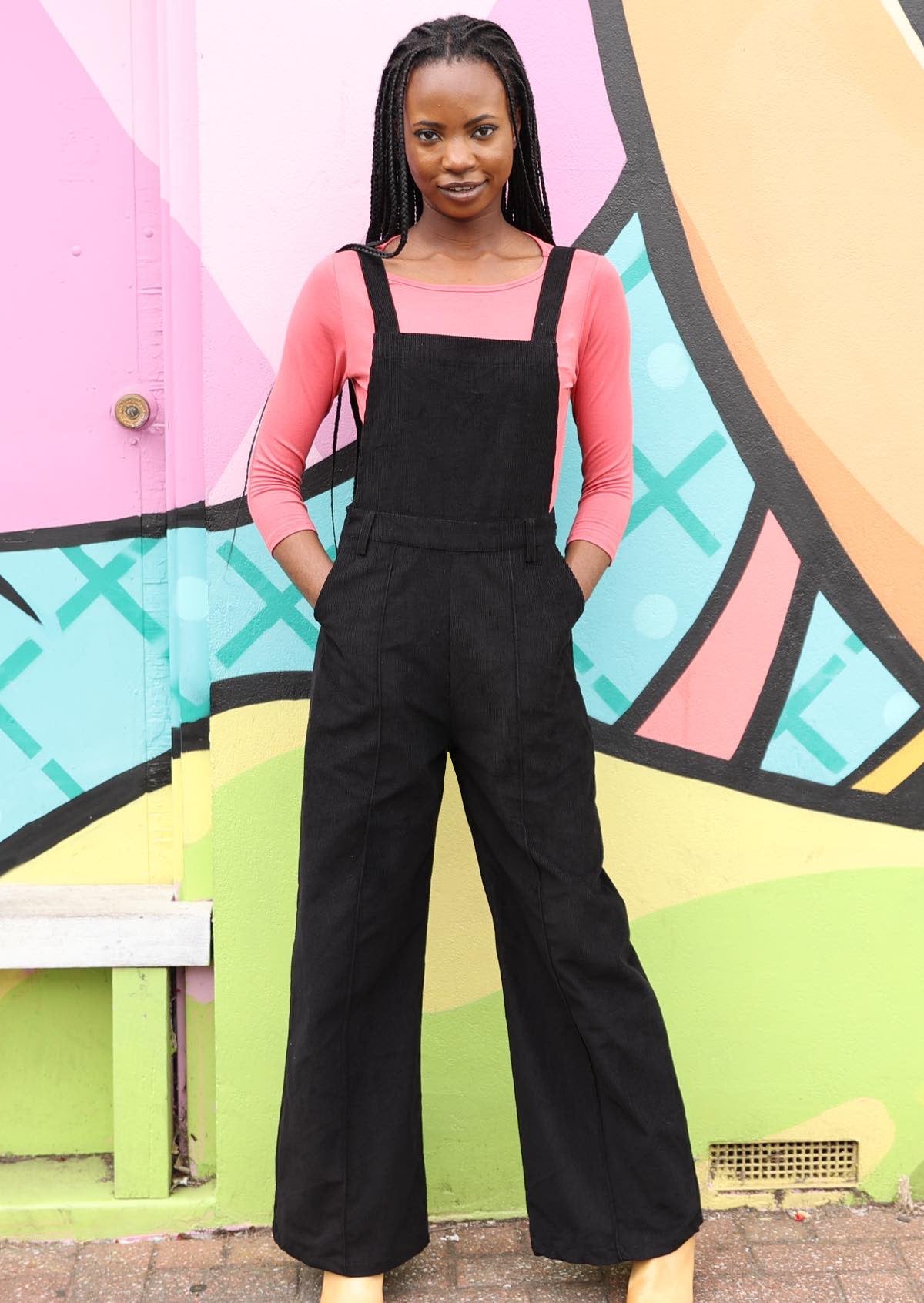 Woman wearing 100% cotton corduroy overalls in black