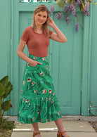 Model wears green floral print cotton midi skirt with pockets