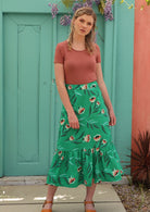 Model wears cotton midi length skirt with back zip and large ruffle