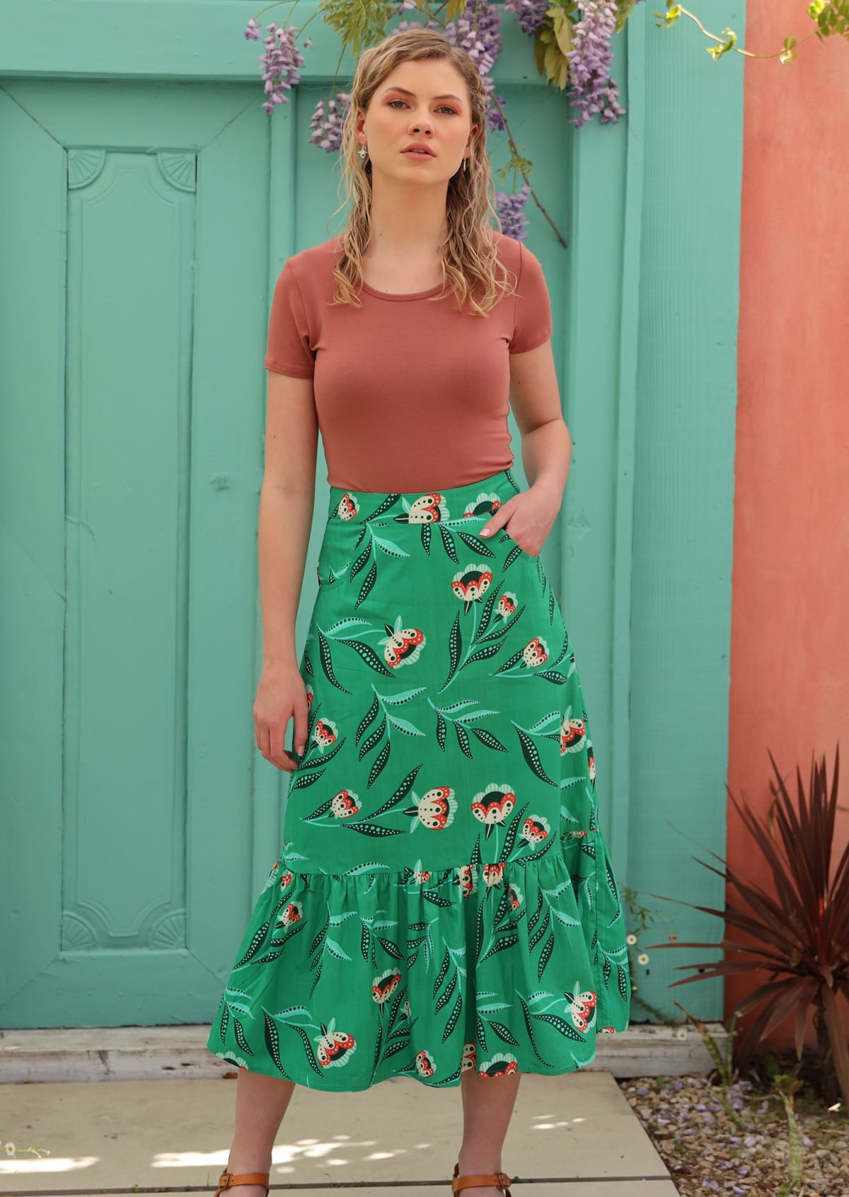 Model wears mint green midi length skirt with large ruffle