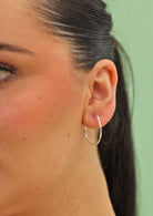 92.5 silver hoop earring on woman's ear