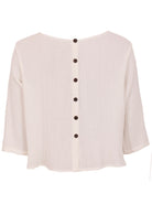 Natural white double cotton 3/4 sleeve top with decorative buttons down centre back
