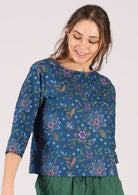 Model wears blue floral 100% cotton top with a round neck. 