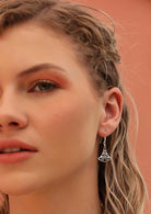 Blond woman wearing Celtic silver earrings 