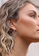 Woman with curly blonde hair wearing Divine Droplet Boho Silver Earrings