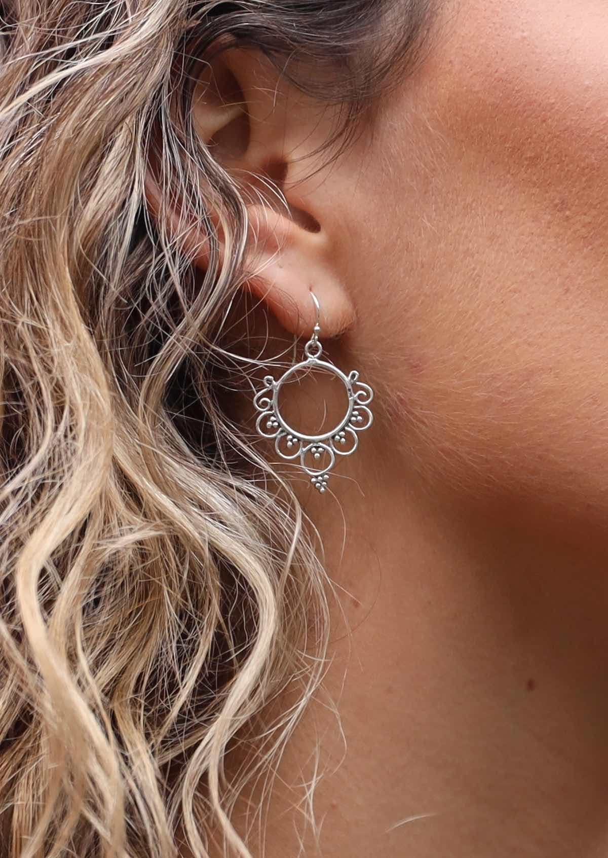 Woman with curly blonde hair wearing Divine Droplet Boho Silver Earring
