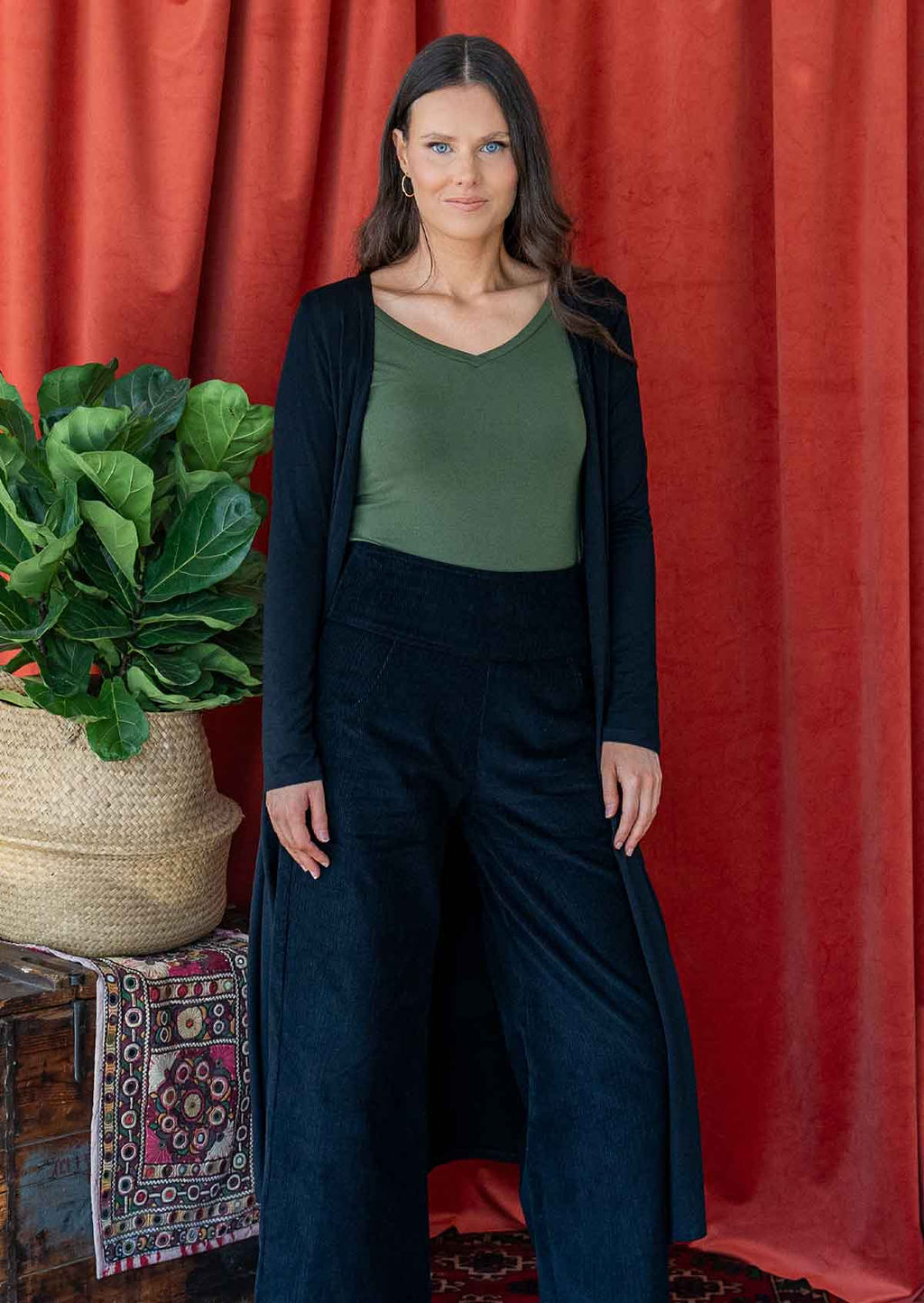 Woman wearing long black stretch jersey duster jacket 