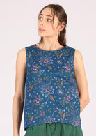 Model wears 100% cotton blue top with a round neckline. 