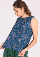 Model wears breathable cotton top with no sleeves. 