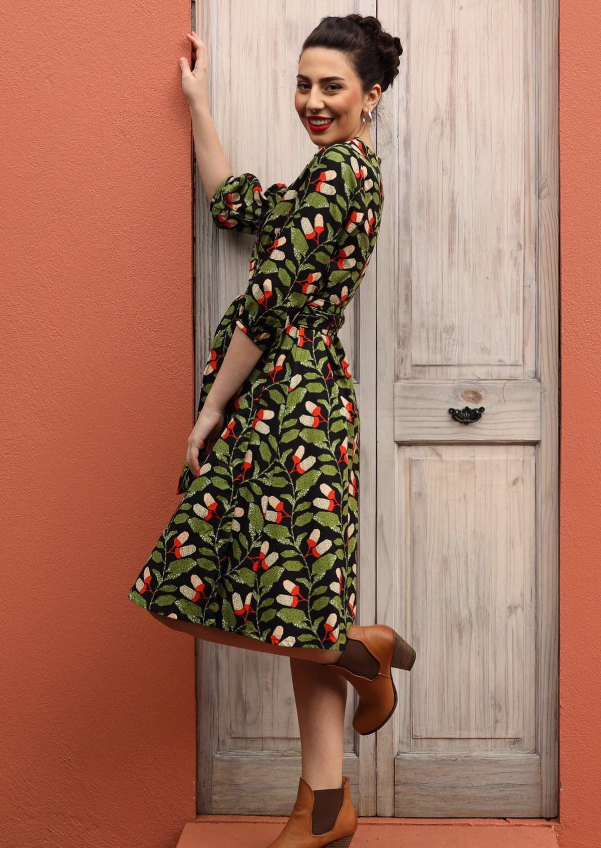 Model wears cotton wrap dress with 3/4 sleeves