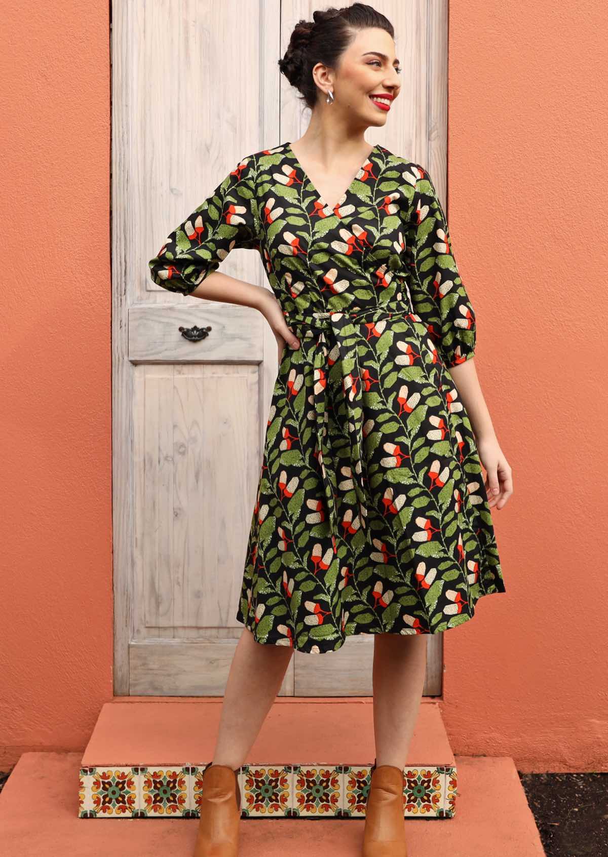 Model wears green and black print cotton wrap dress with V-neck