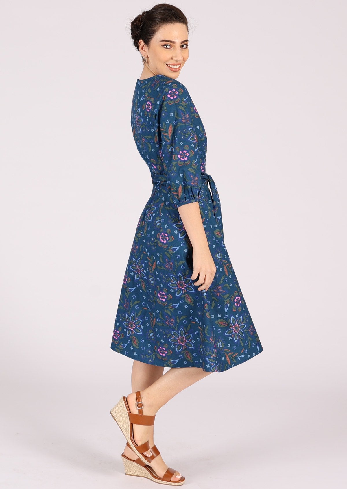 Cotton blue based floral dress has voluminous 3/4 sleeves.