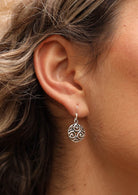 close up of silver Celtic earring on ear