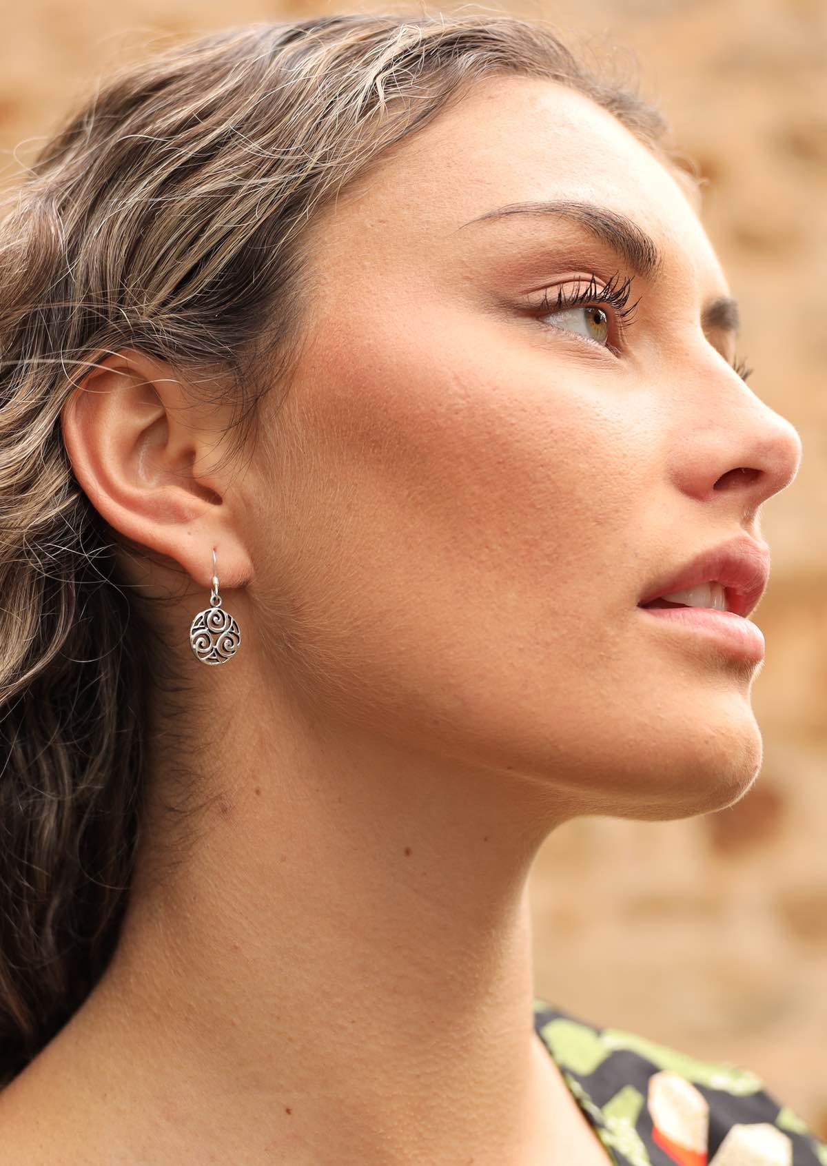 Woman wearing silver Celtic earring
