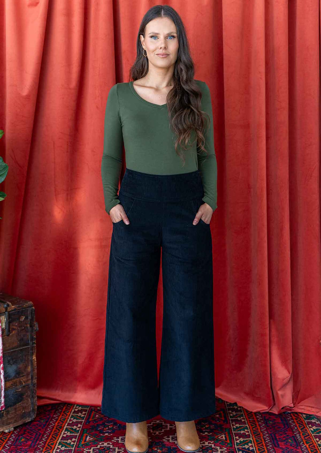 woman wearing black cotton corduroy wide leg pants with hand in pockets